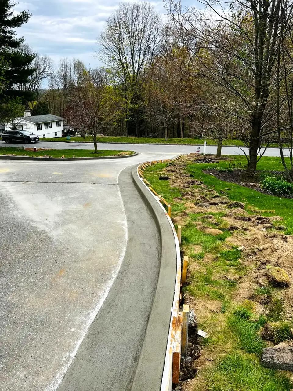 Newly poured concrete driveway and curb construction at a Massachusetts home