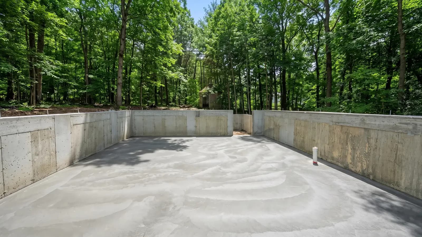Newly poured concrete slab inside foundation walls during new construction