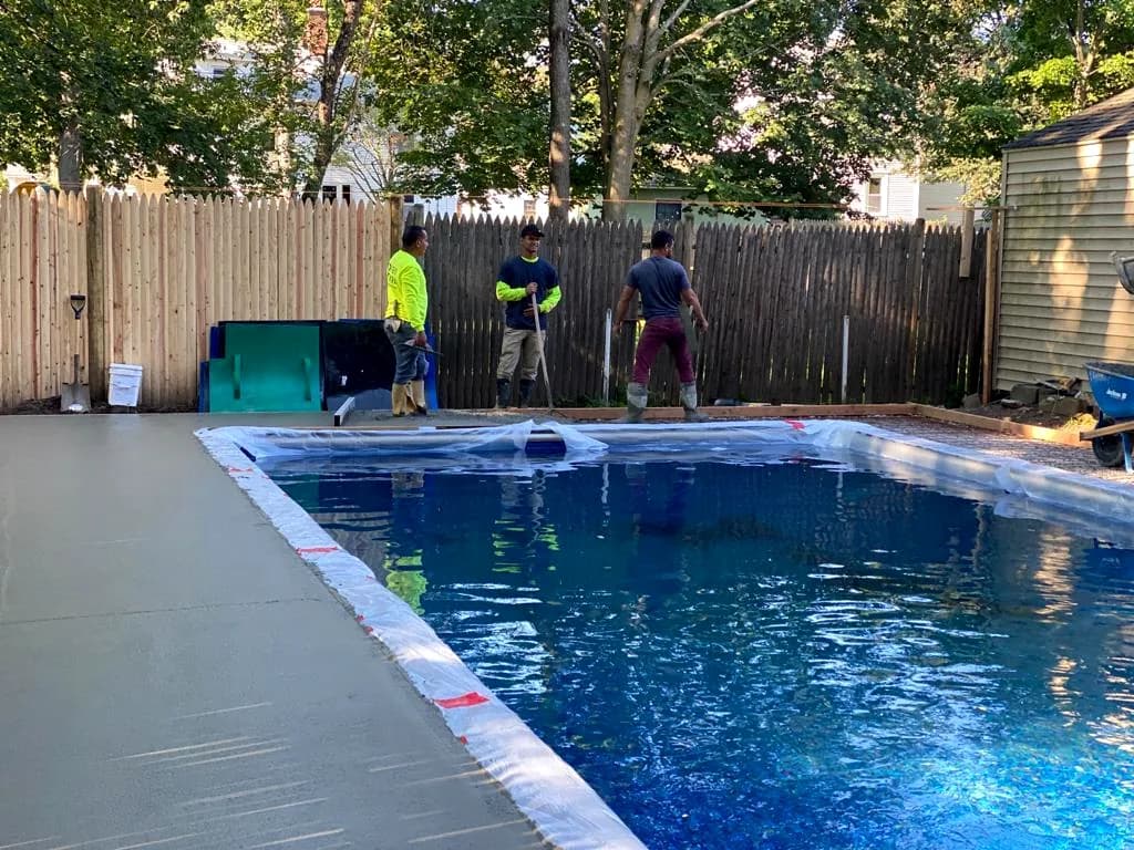WR Concrete crew finishing the fresh pool deck concrete