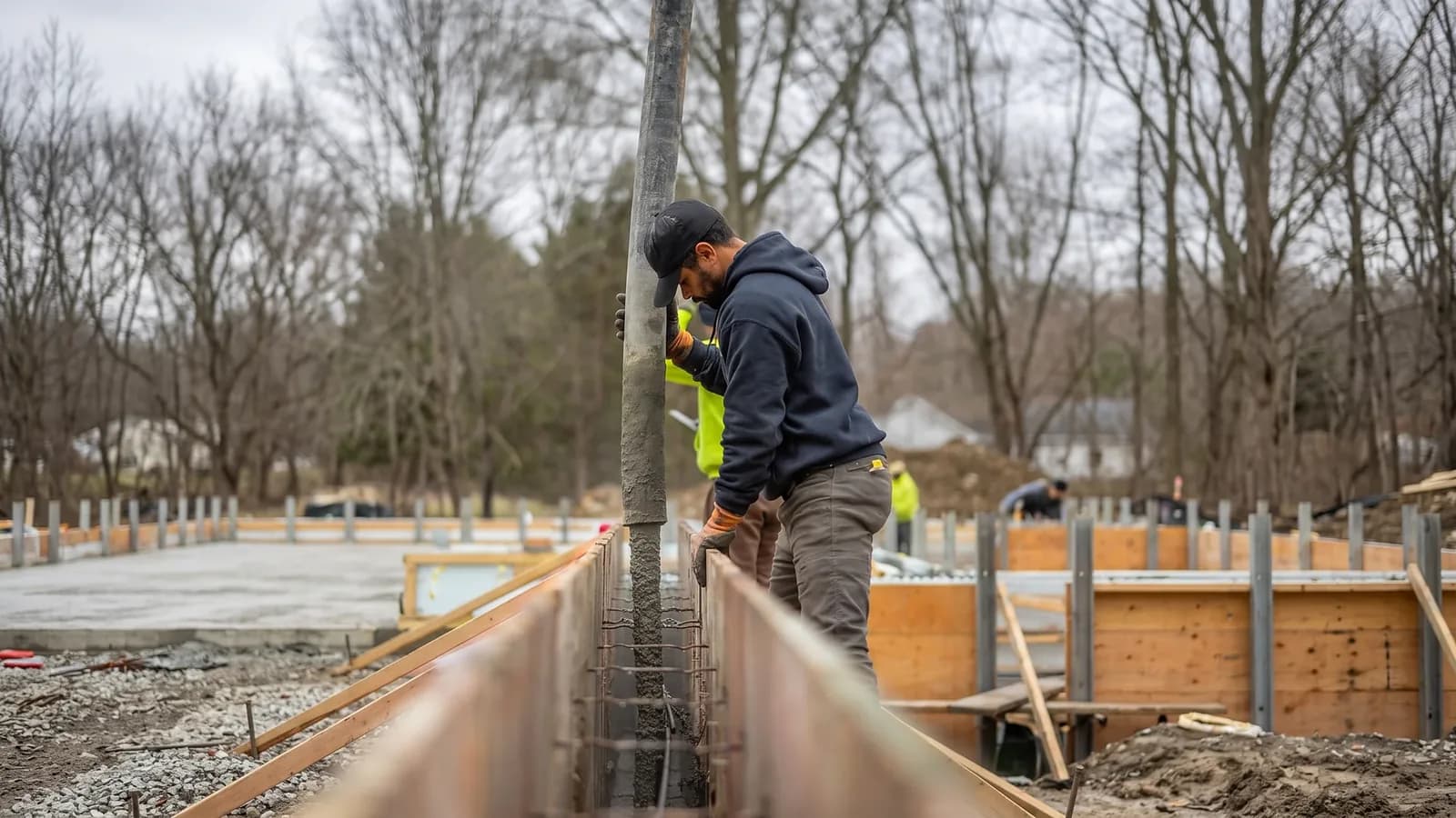 WR Concrete crew pouring concrete into foundation forms